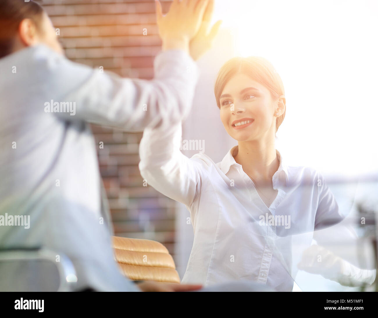 members of the business team giving each other a high five Stock Photo ...