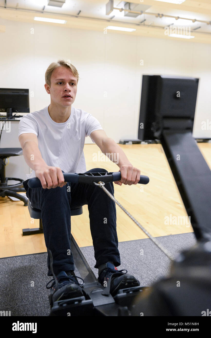 school students using the indoor gym equipment in a PE lesson Stock