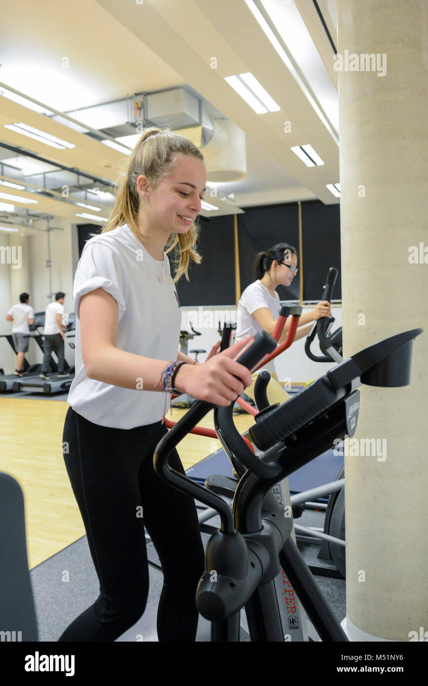 school students using the indoor gym equipment in a PE lesson Stock