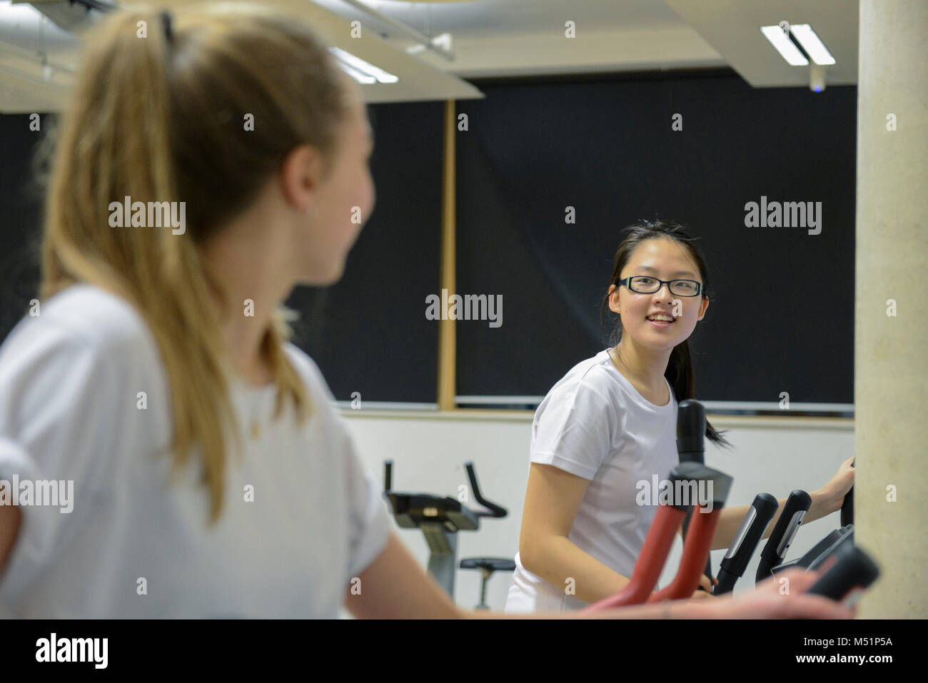 school students using the indoor gym equipment in a PE lesson Stock