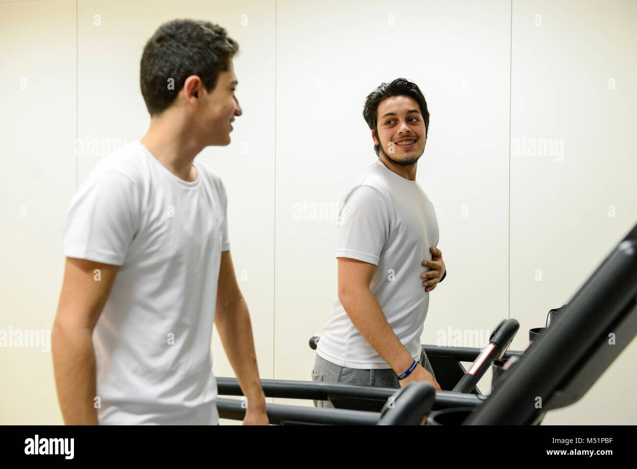school students using the indoor gym equipment in a PE lesson Stock
