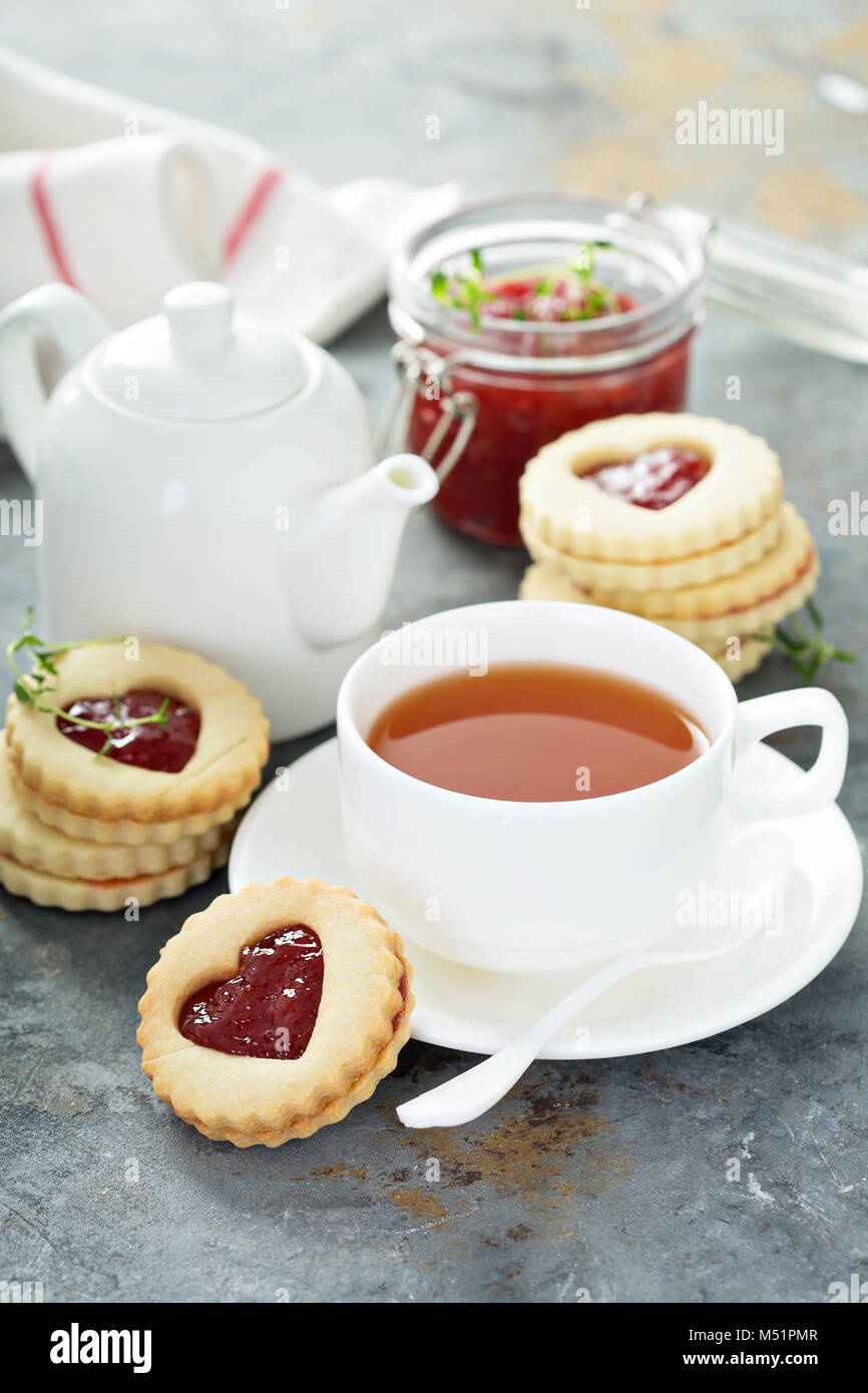 Vanilla linzer cookies with strawberry jelly filling and heart cutouts