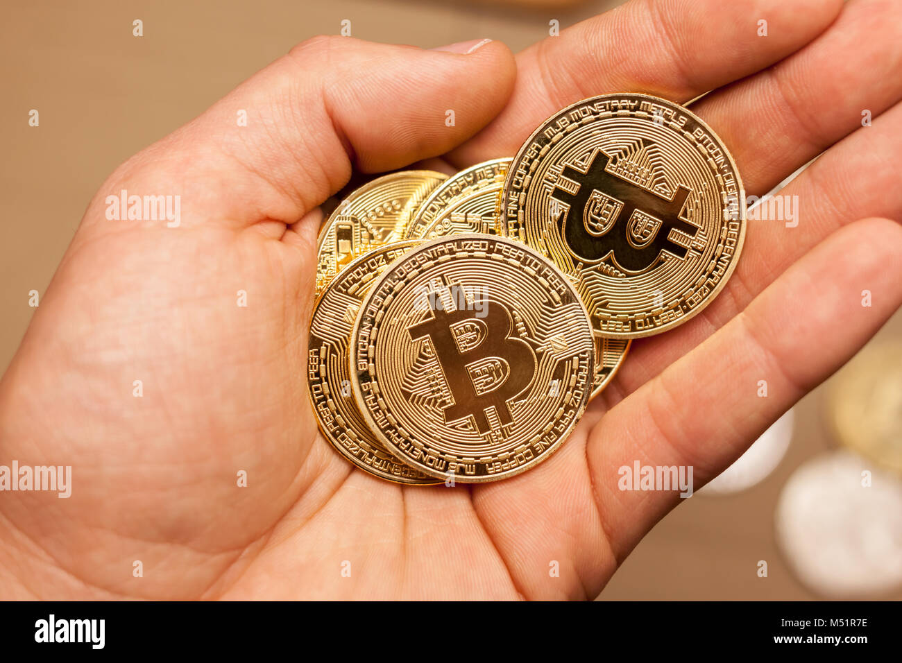 golden bitcoin coins in the hand Stock Photo - Alamy