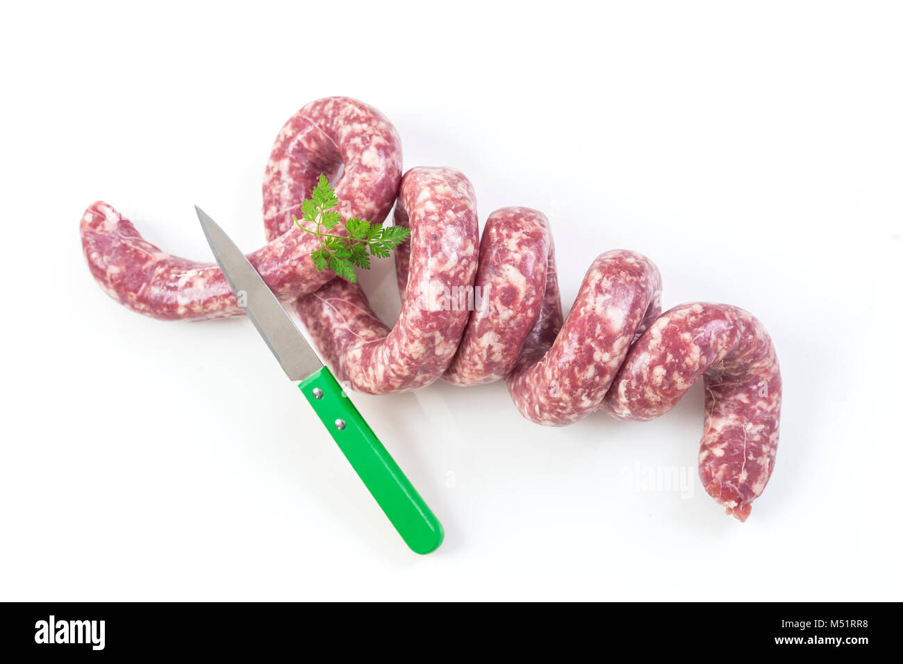 Toulouse sausage Raw 'saucisse de toulouse' twisted f,rench meat specialty from Toulouse on white Stock Photo