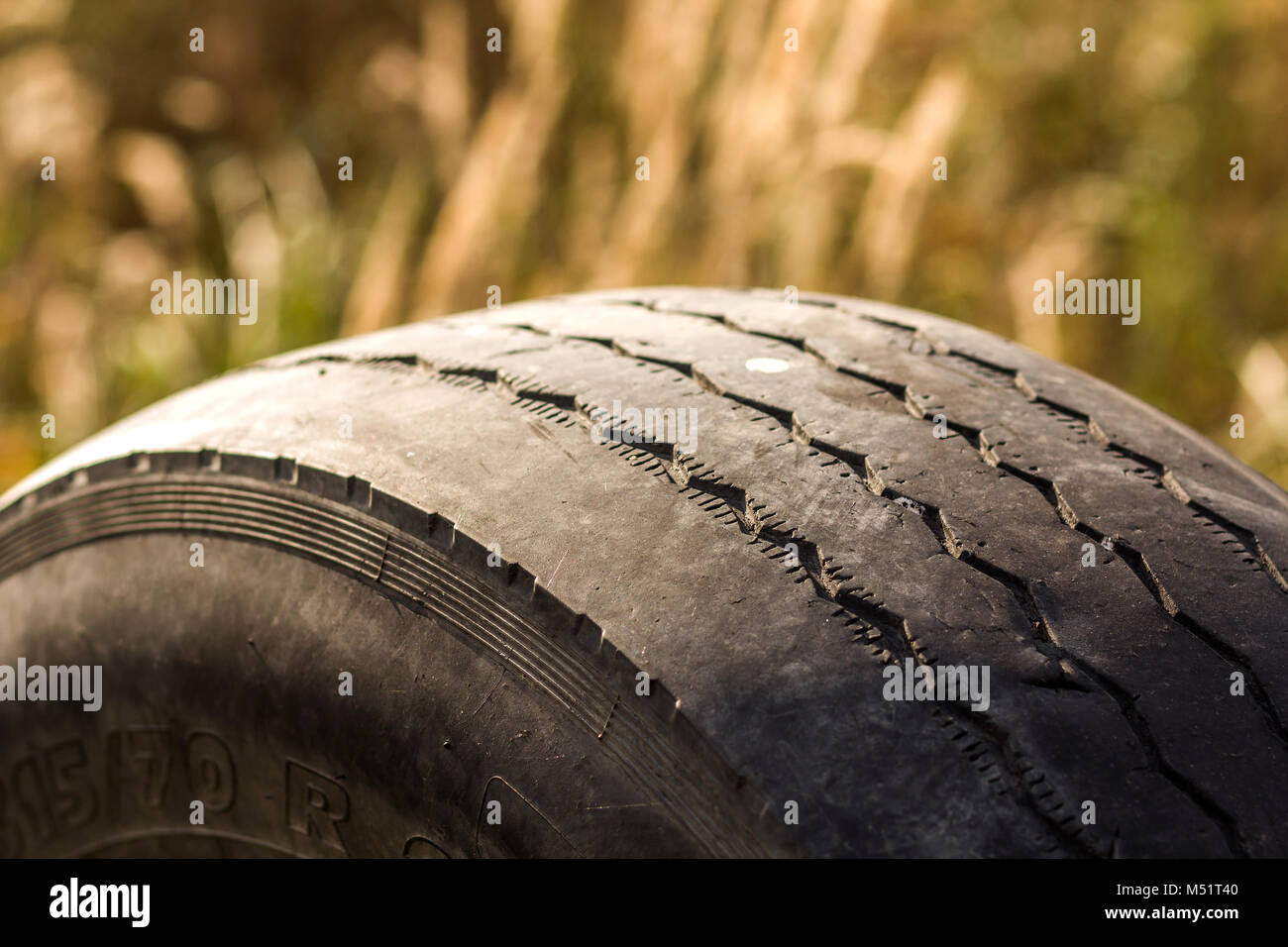 Closeup detail of car wheel tire badly worn and bald because of poor