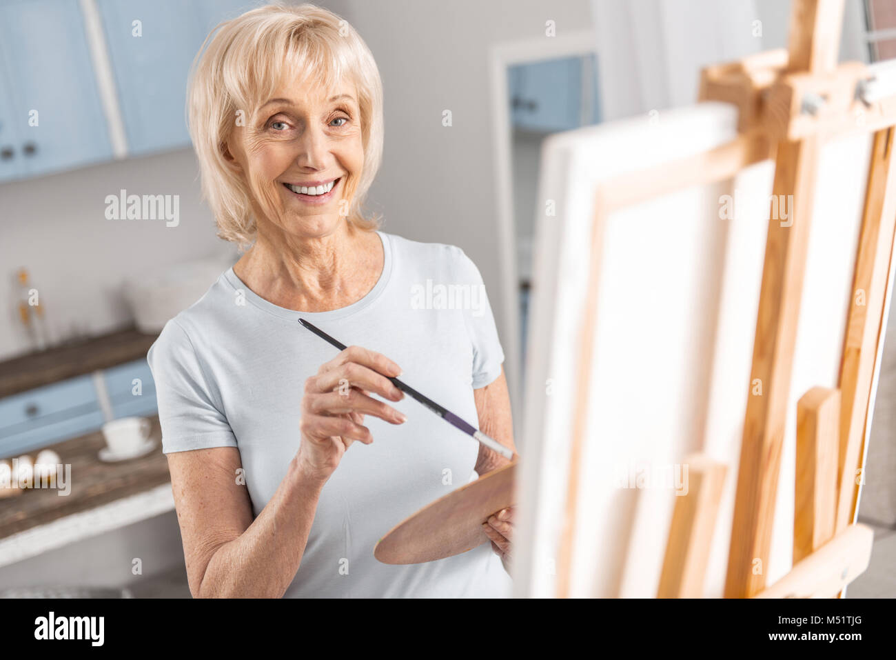 Joyful mature woman enjoying hobby Stock Photo