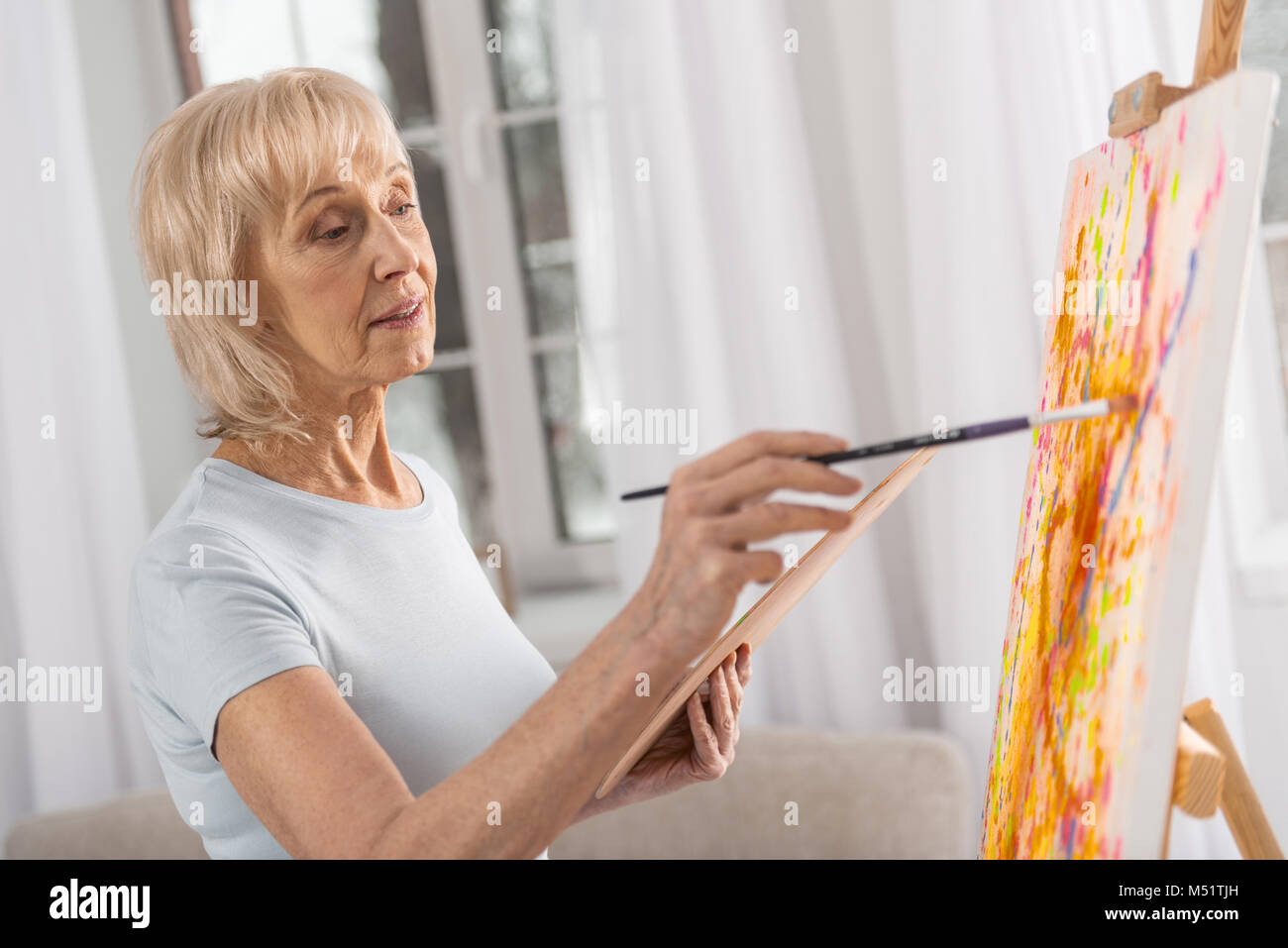 Talented mature woman involving in drawing Stock Photo