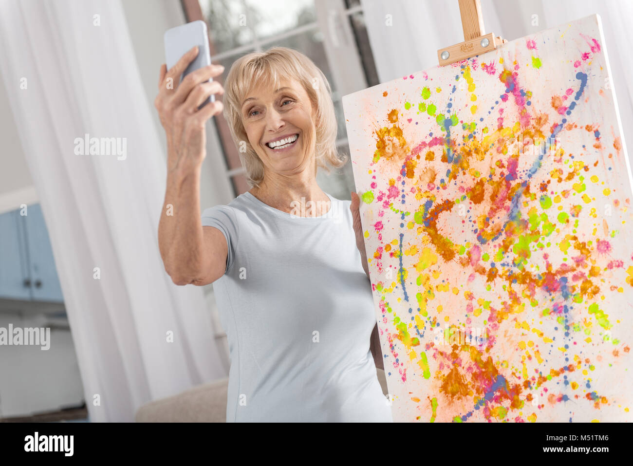 Merry mature woman collecting memory Stock Photo