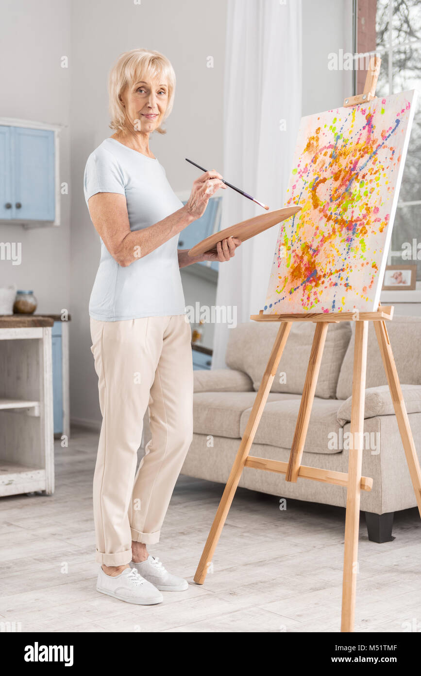 Pensive mature woman drawing abstraction Stock Photo