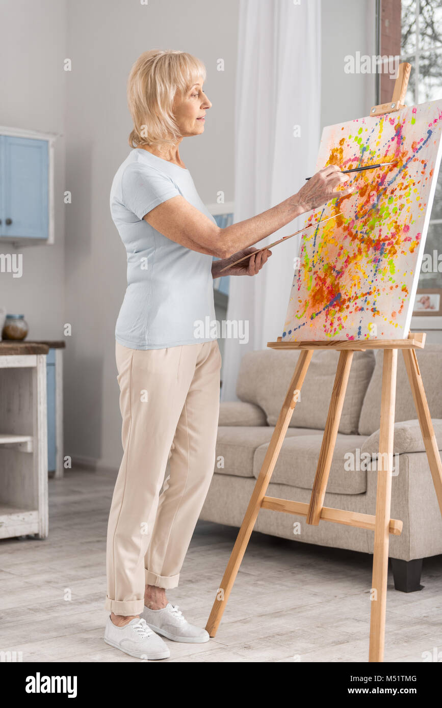 Inspired mature woman painting abstraction Stock Photo