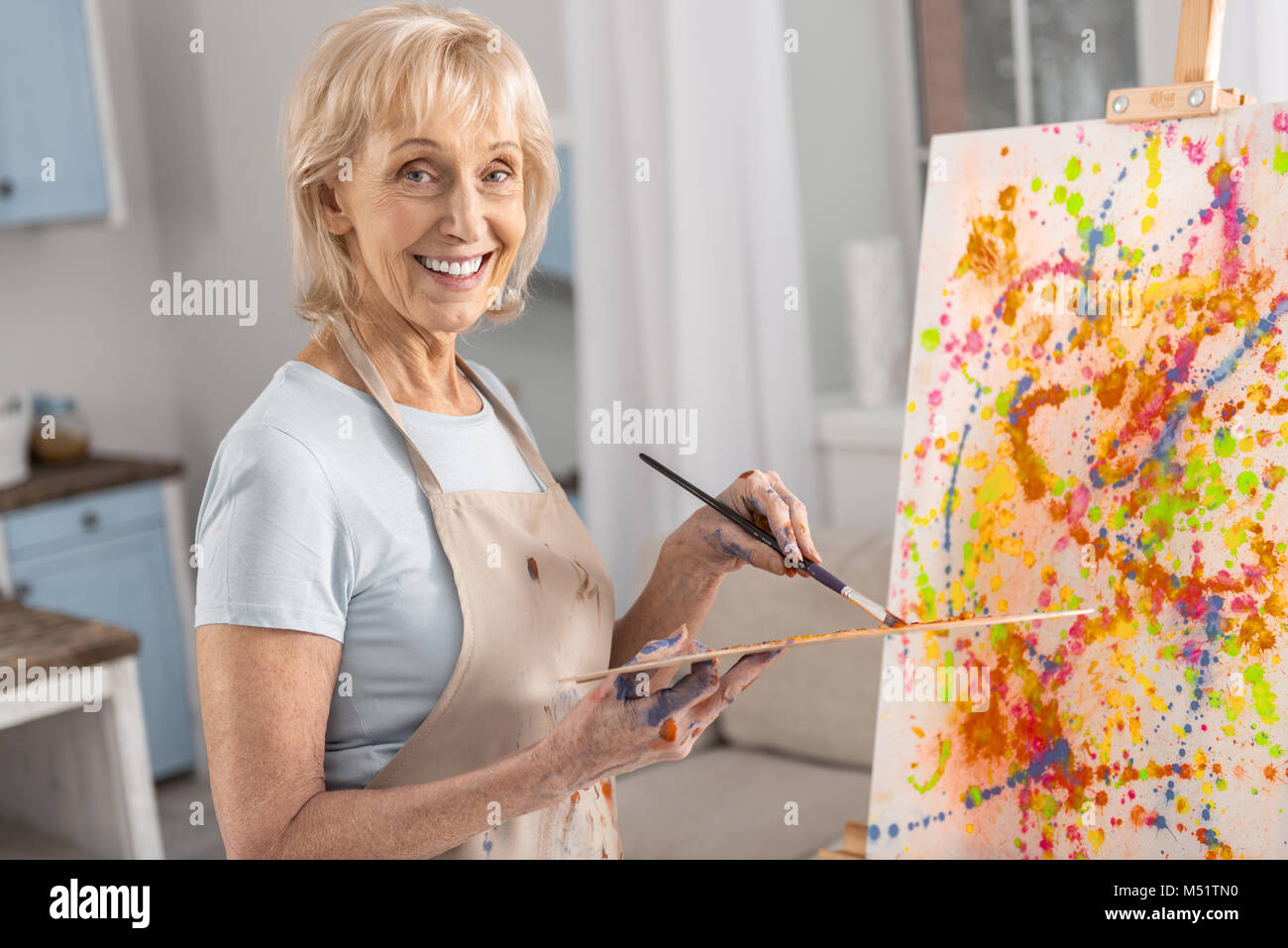 Happy mature woman creating her vision Stock Photo