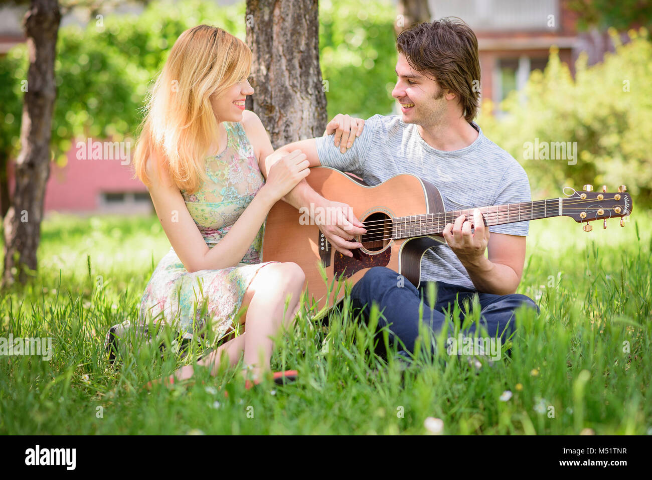 Sweet couple in love in the park Stock Photo - Alamy