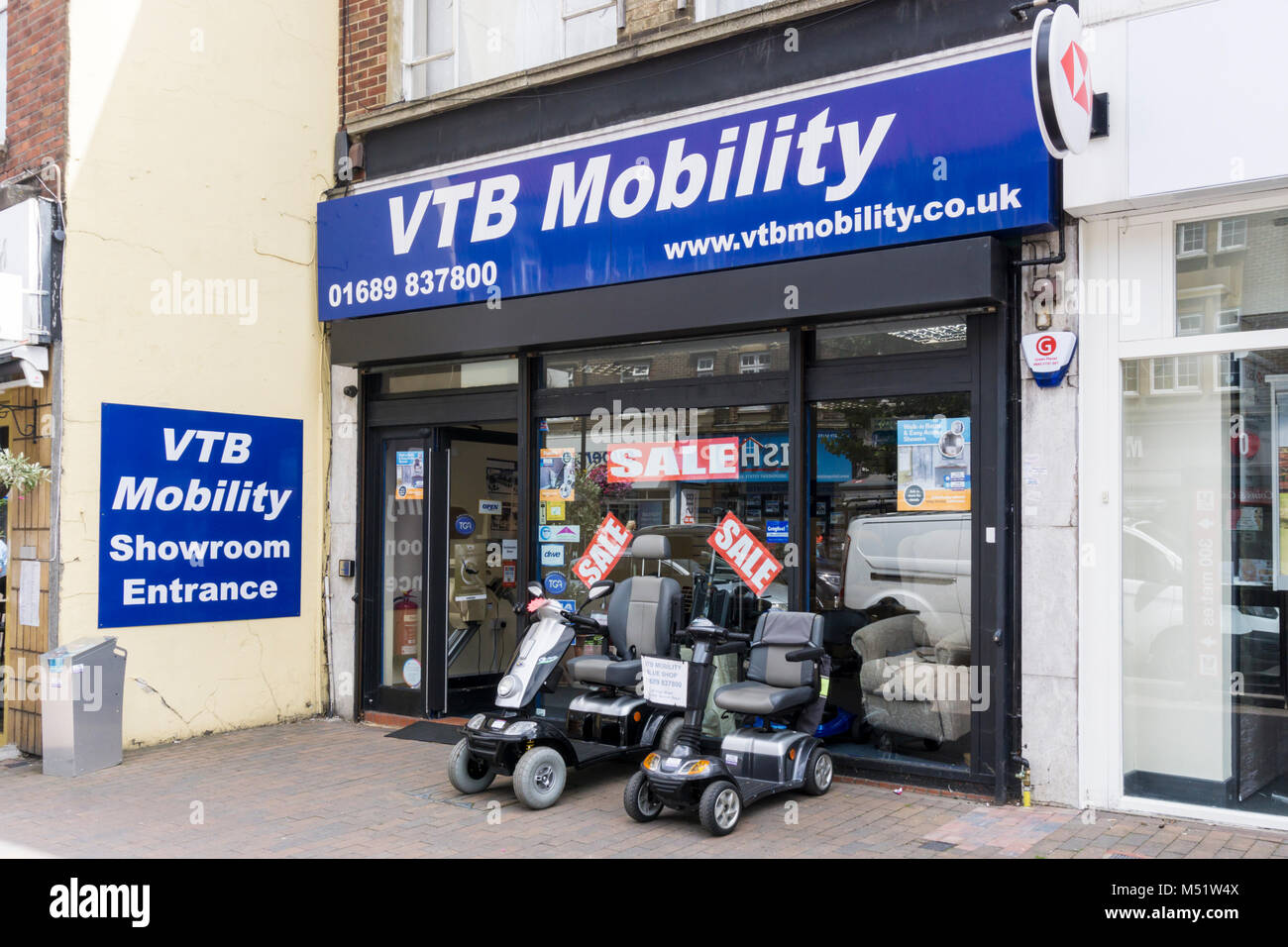 VTB Mobility in Orpington High Street with mobility scooters for sale outside the shop Stock Photo