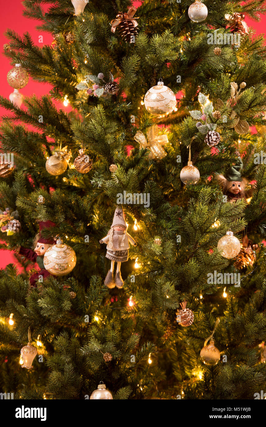 Christmas Tree on red background decorated with golden balls toys and ...