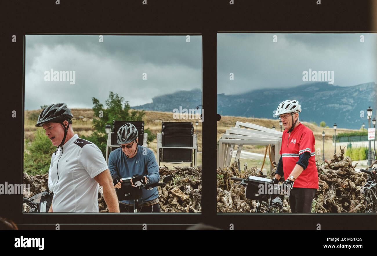 Group of cyclists with helmets behind window, Pamplona, Navarre, Spain Stock Photo