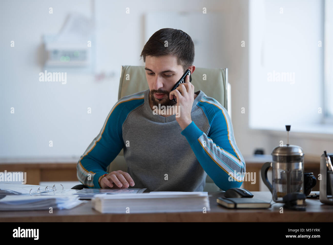 He is working in the office. He is working in the office