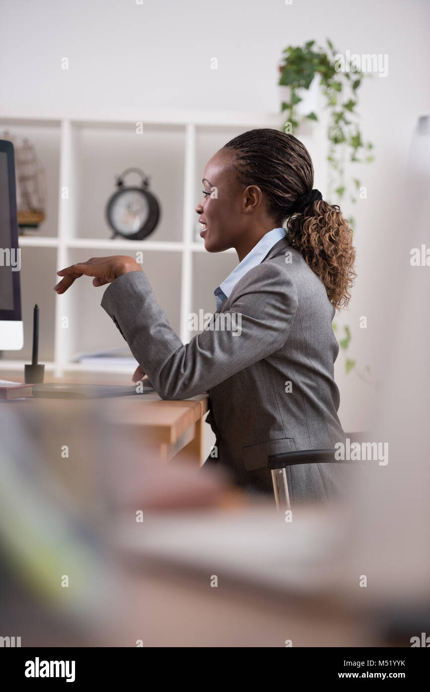 African pretty business woman working at pc in office Stock Photo - Alamy