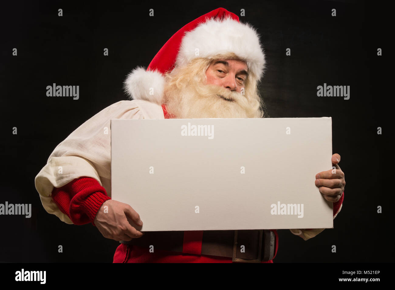 Santa Claus holding white blank sign with fun and smile standing ...