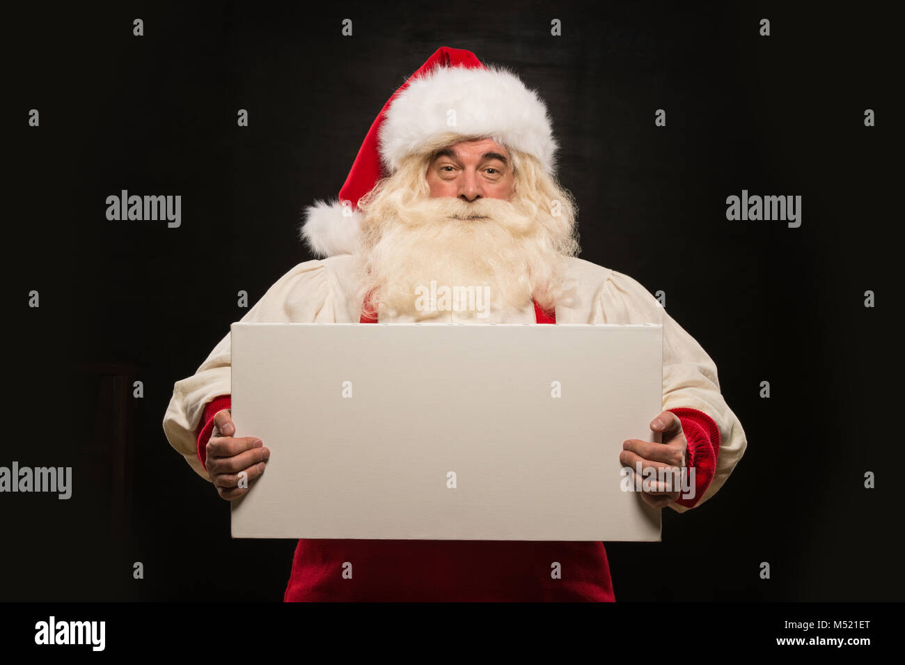 Santa Claus holding white blank sign with fun and smile standing ...