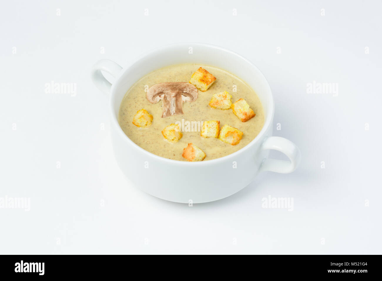 Mushroom cream soup with croutons. White background Stock Photo - Alamy
