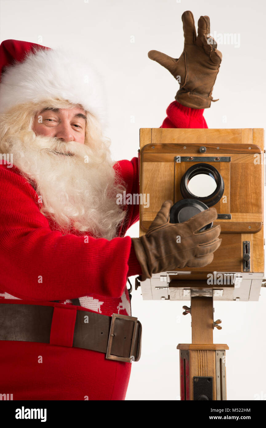 Santa Claus taking picture with old wooden camera. Closeup portrait ...