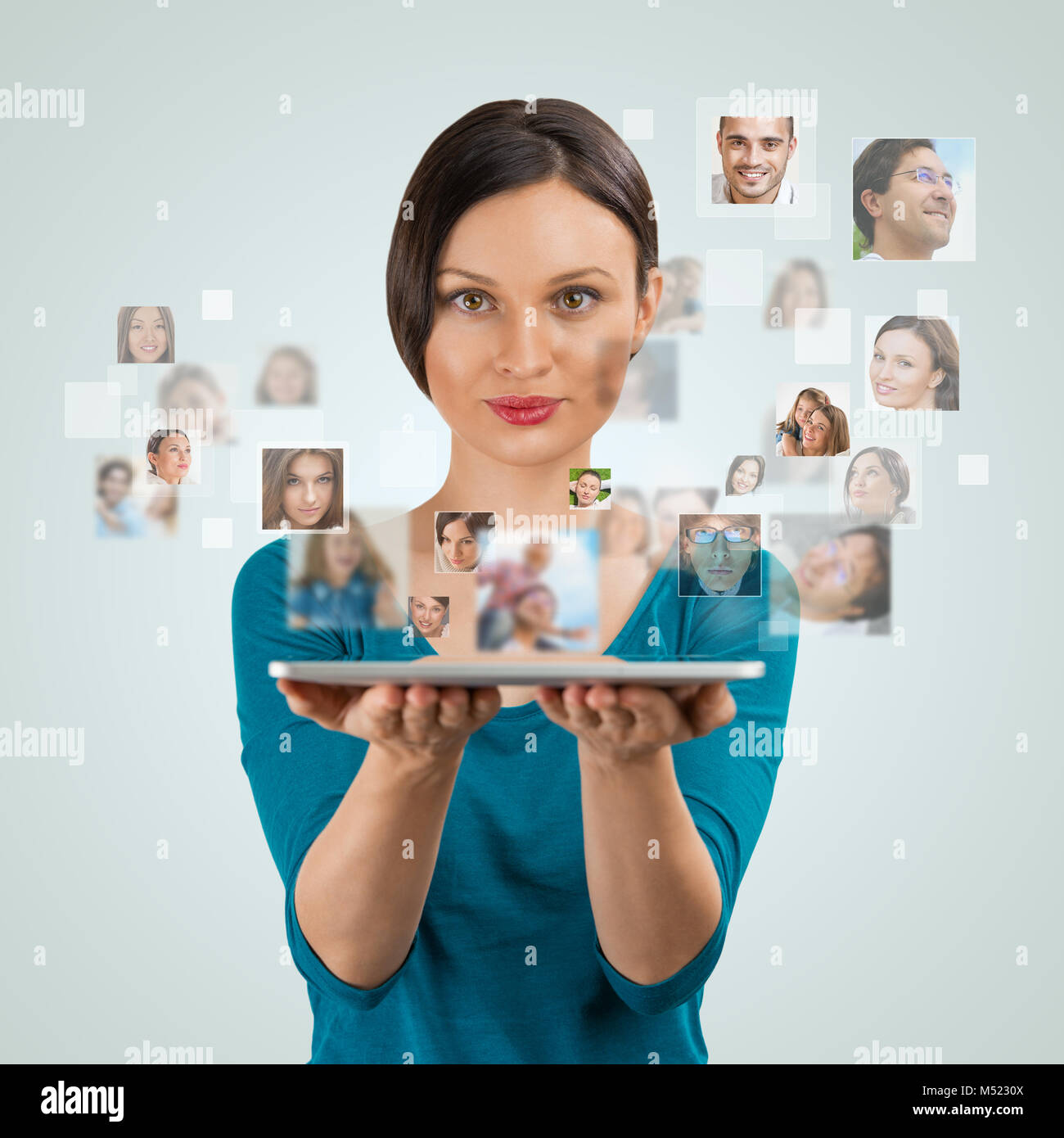 Young woman standing and smiling with many different people's faces ...