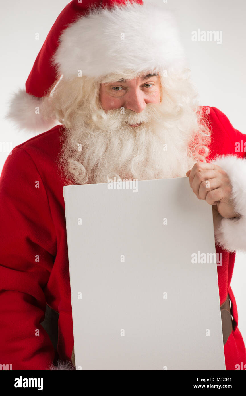 Santa Claus holding white blank sign with smile Stock Photo - Alamy