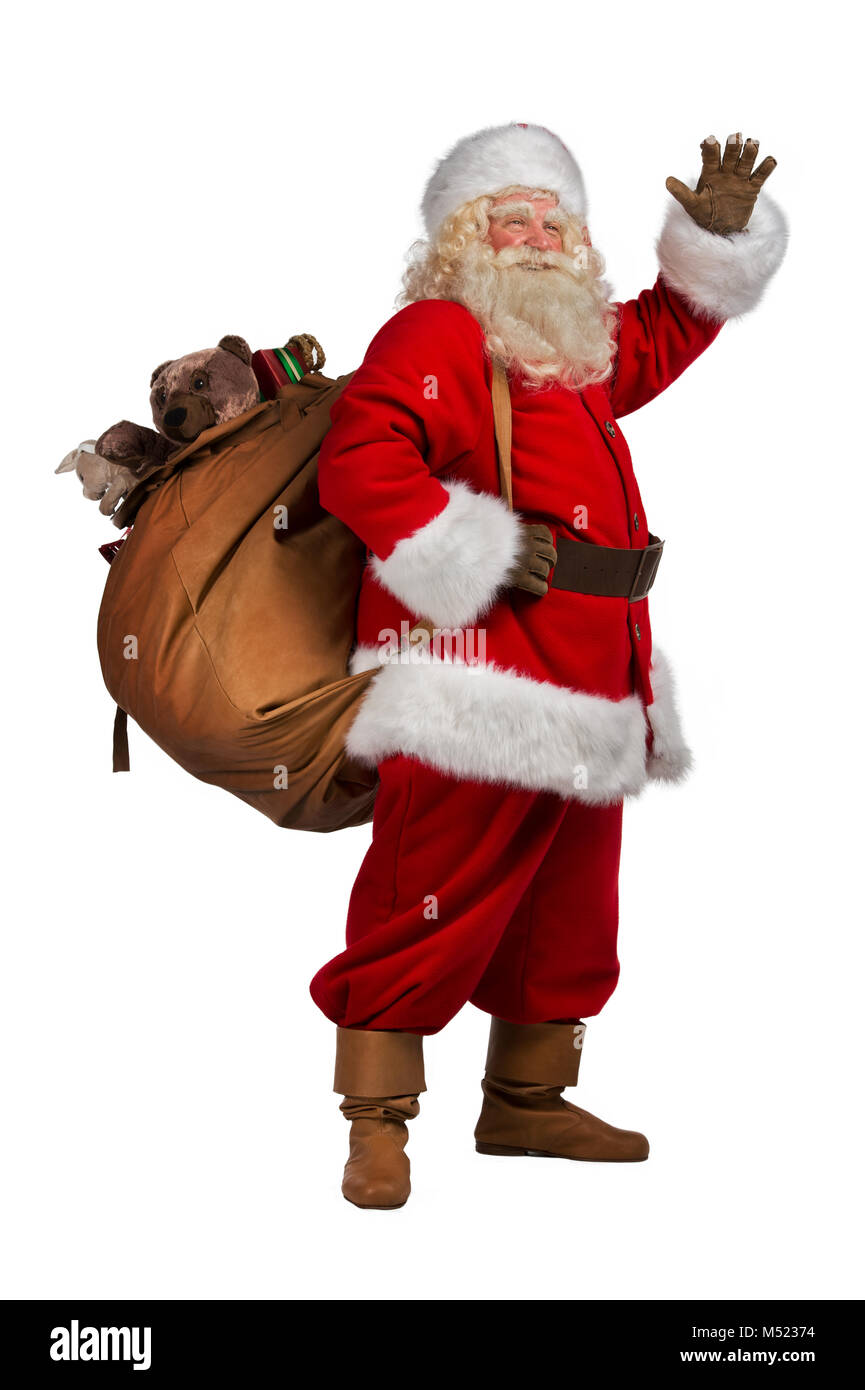 Real Santa Claus carrying big bag full of gifts, isolated on white ...