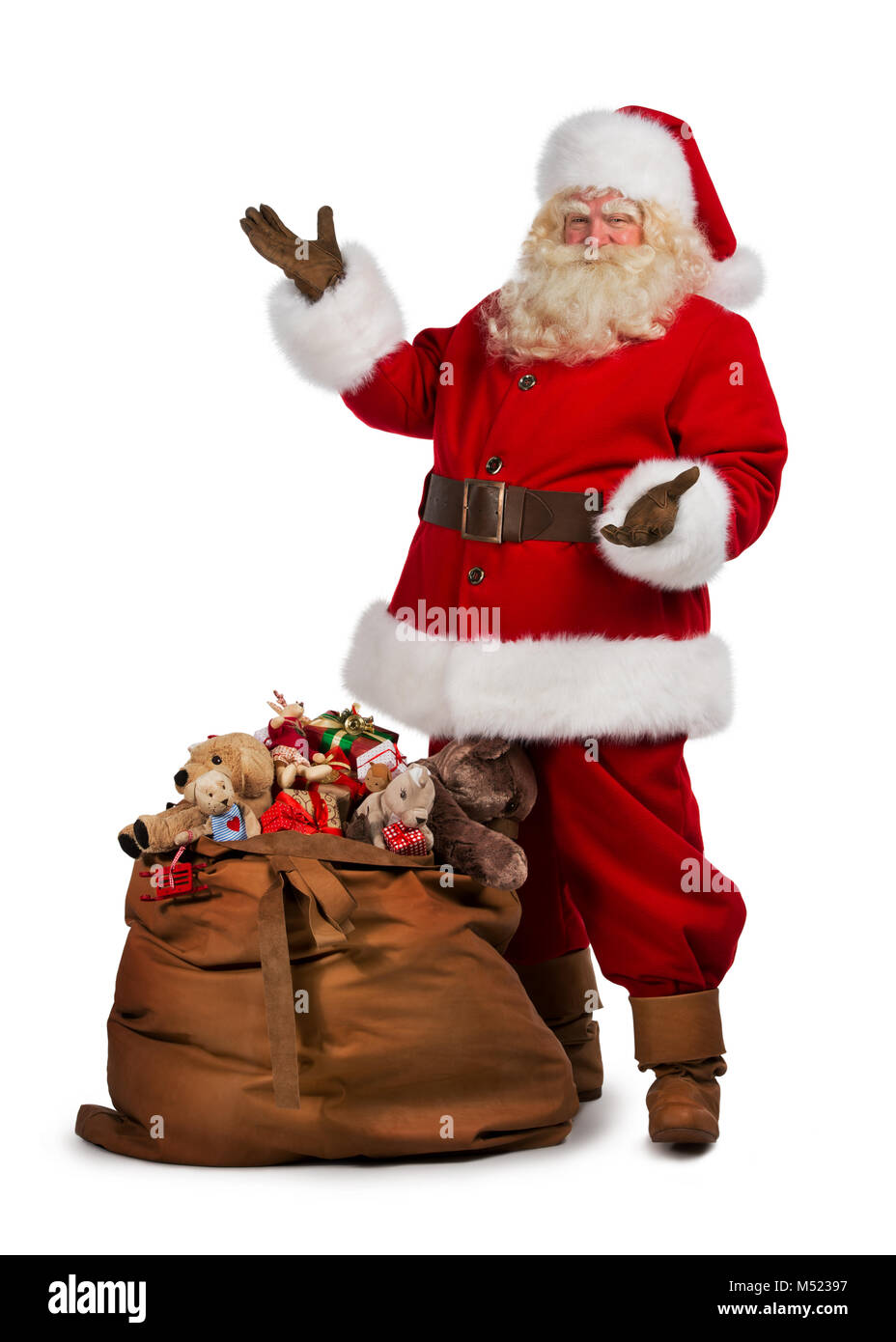 Full length portrait of a Santa Claus posing near a bag full of gifts ...