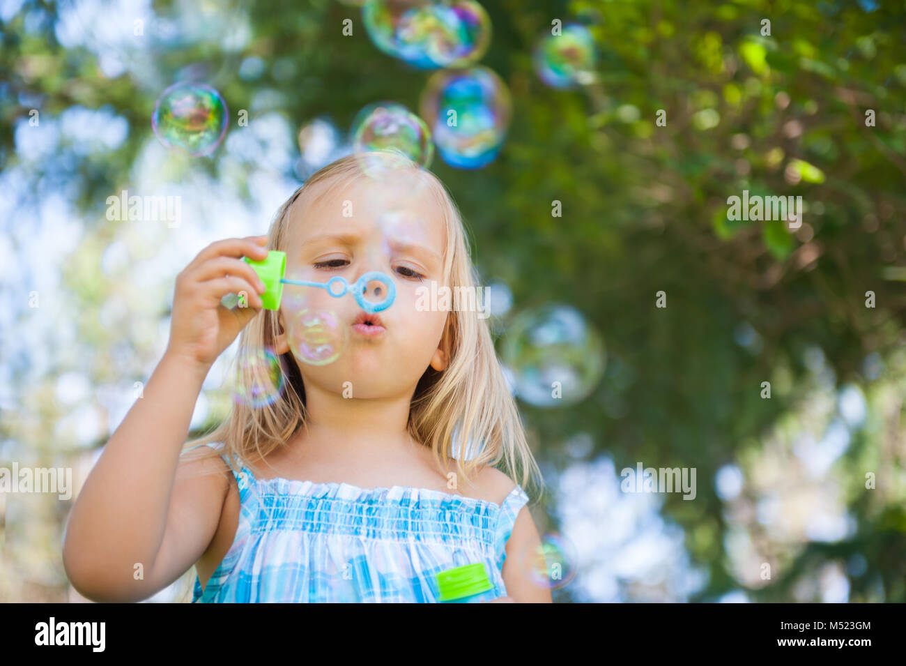 little girl with soap bubbles having fun outdoors Stock Photo - Alamy