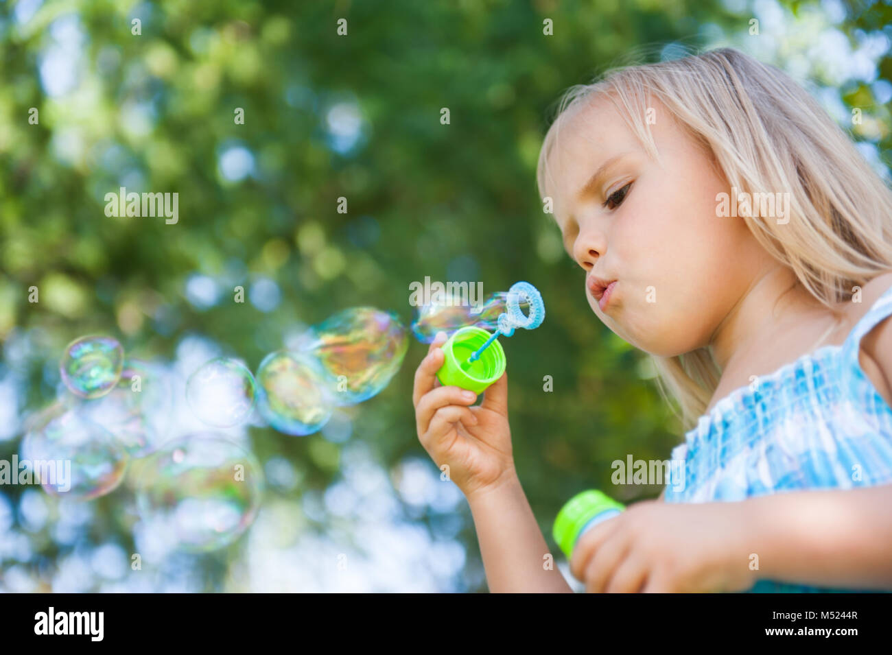 little girl with soap bubbles having fun outdoors Stock Photo - Alamy