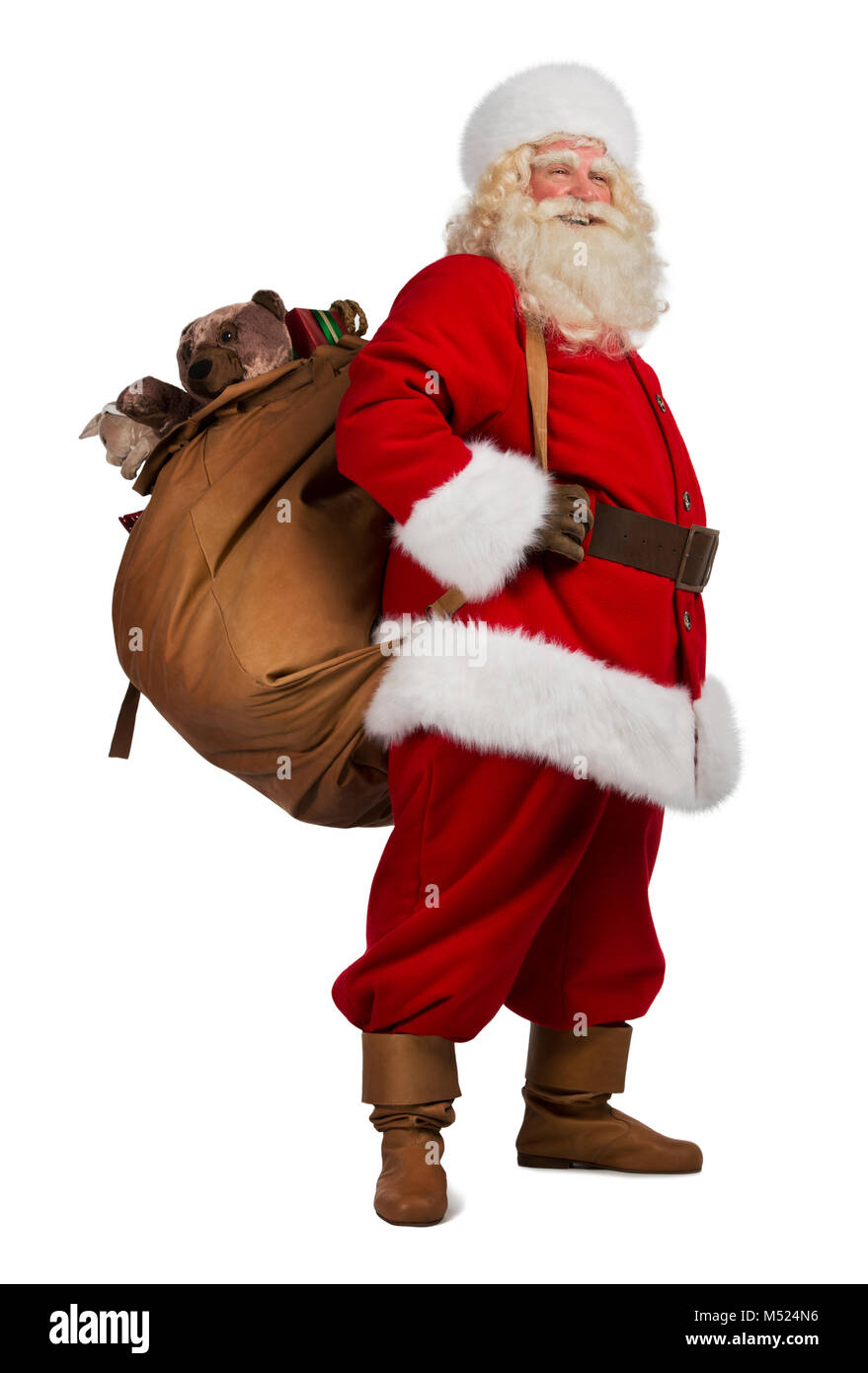 Full length portrait of Real Santa Claus carrying big bag full of gifts
