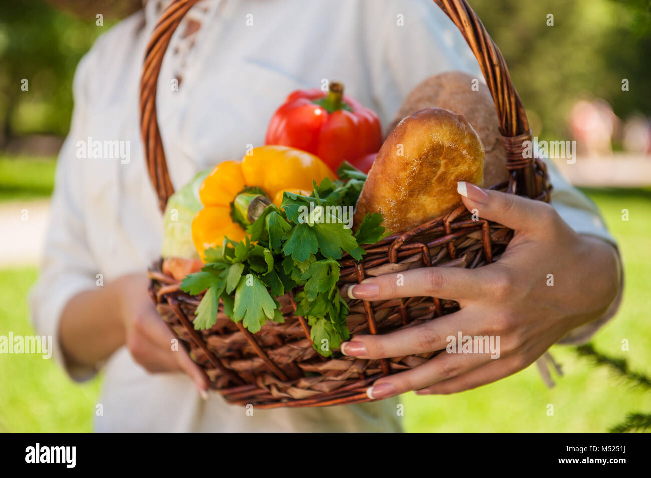 Vegetables in hands. Unrecognizable woman holding basket full of ...