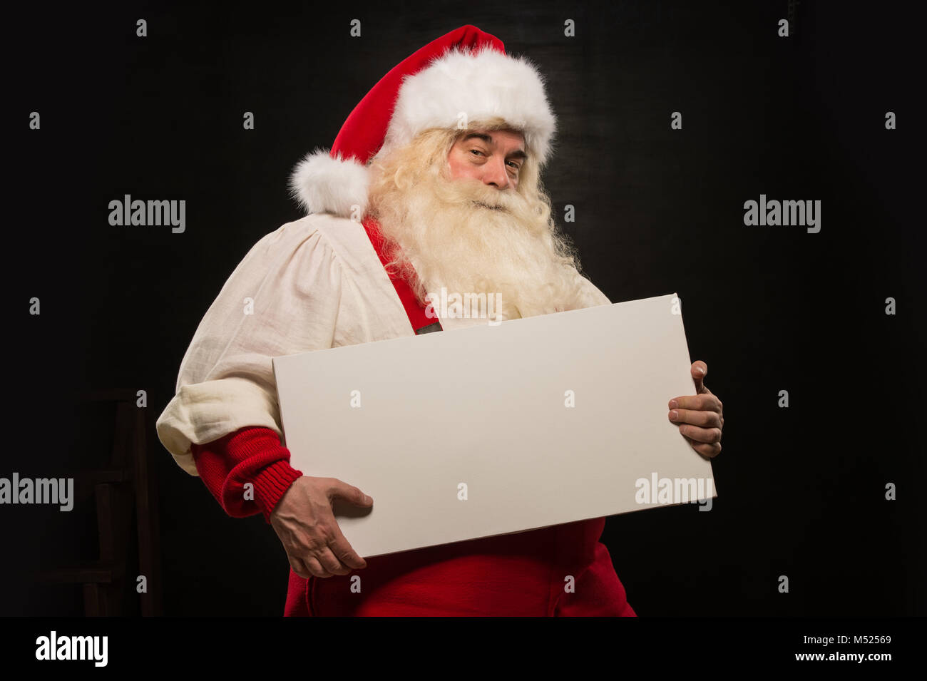 Santa Claus holding white blank sign with fun and smile standing ...