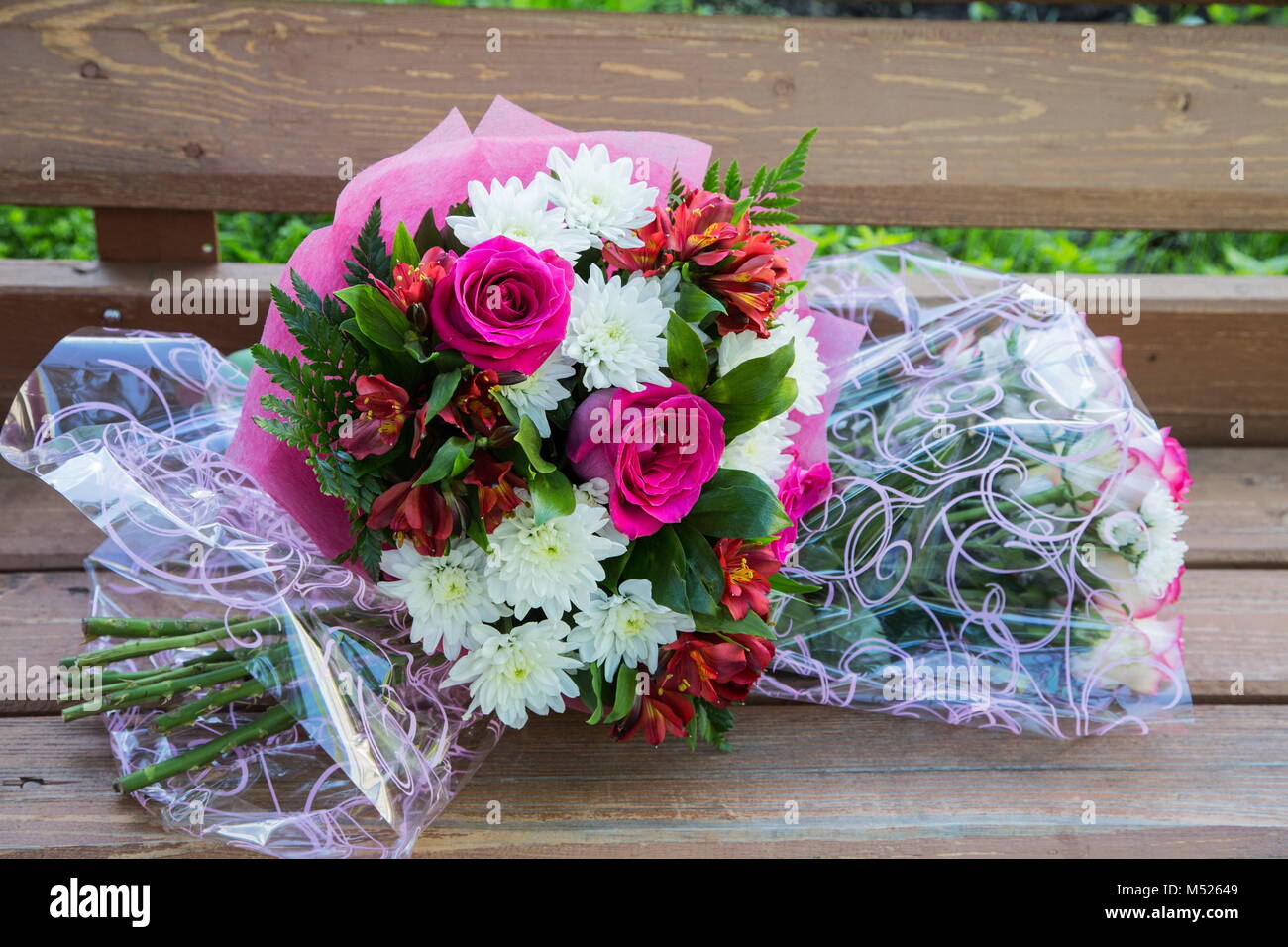 Two bouquets of roses on a bench in the summer Stock Photo