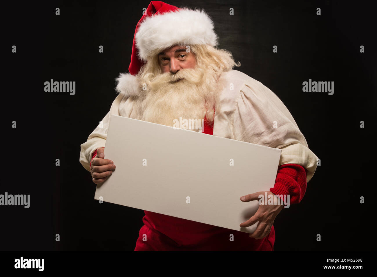 Santa Claus holding white blank sign with fun and smile standing ...