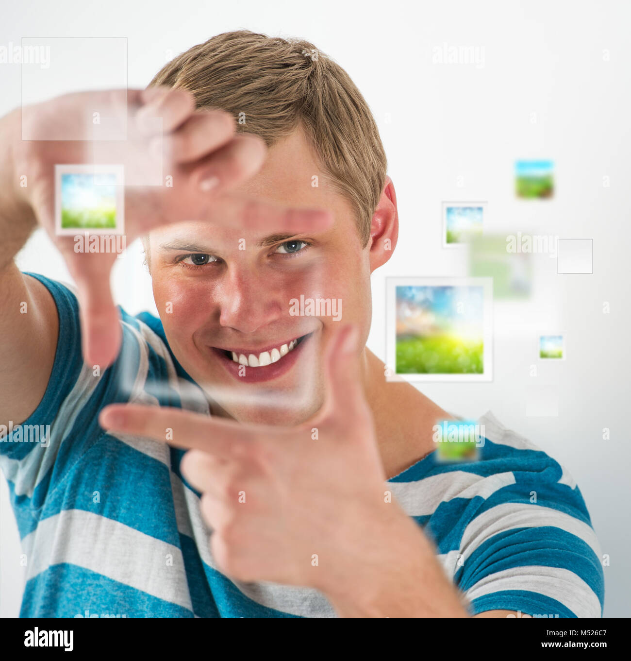 Young man making frame gesture with his fingers, virtual pictures are