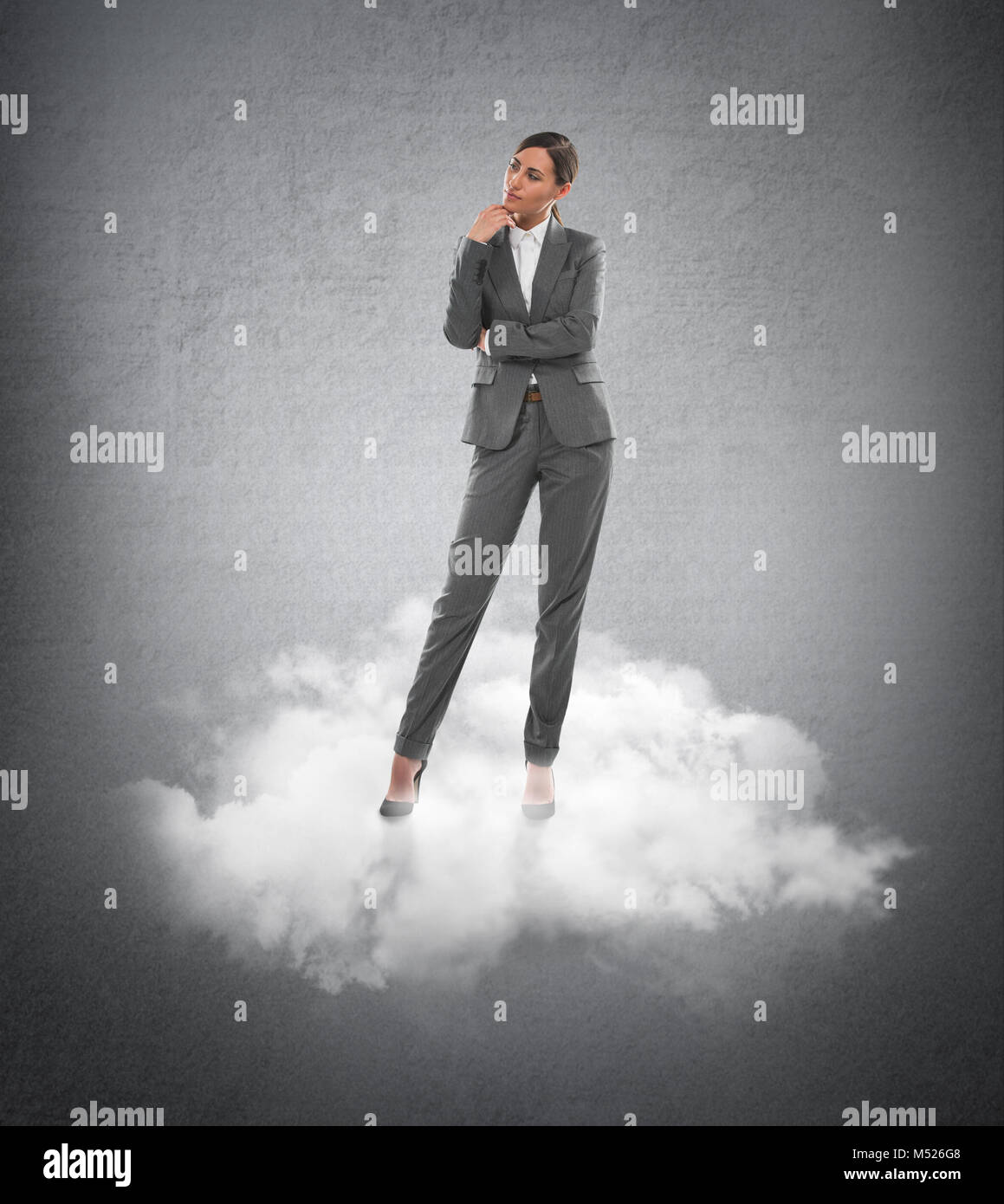Young business woman standing on a cloud Stock Photo - Alamy