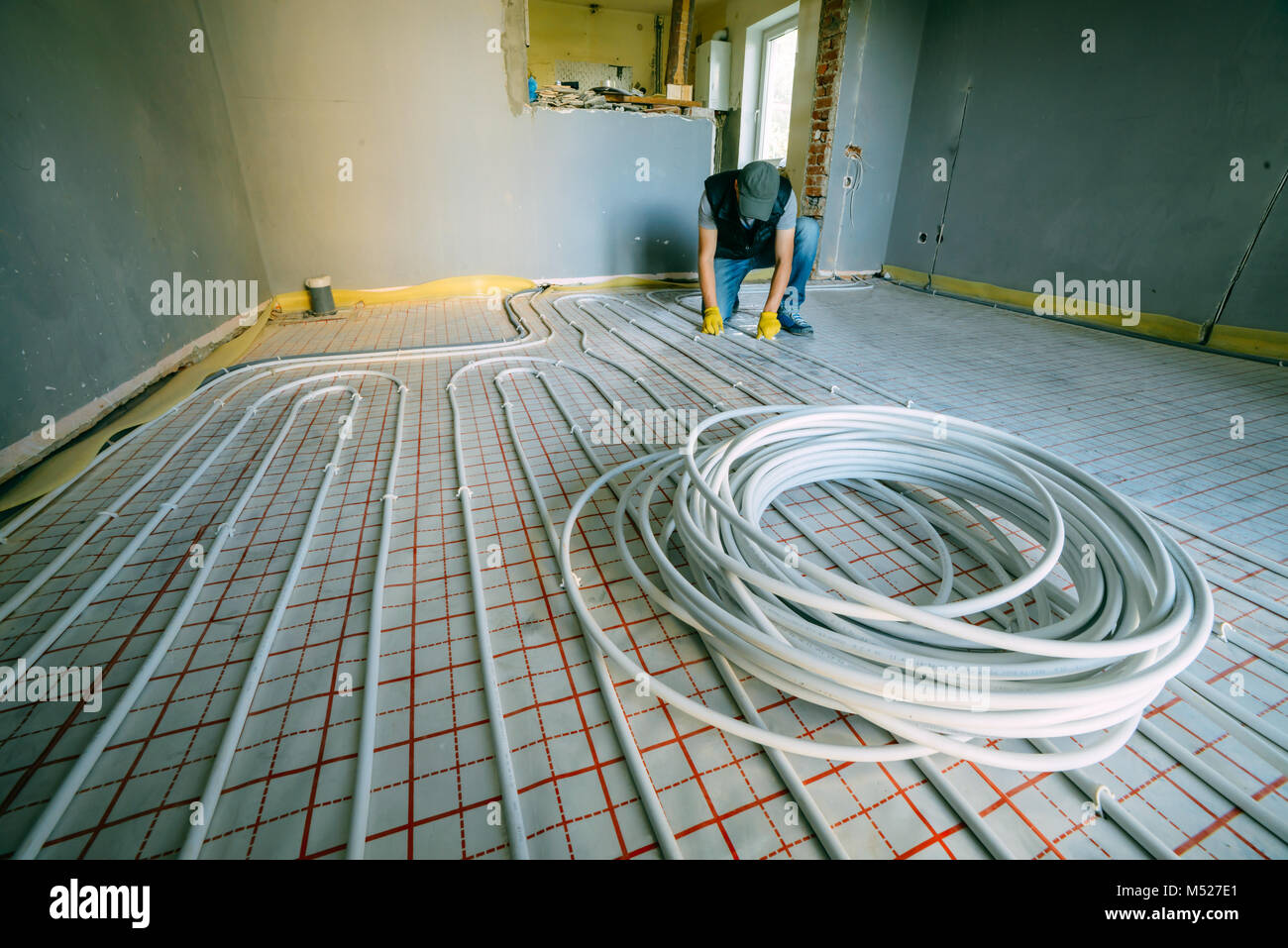 Pipefitter installing system of heating Stock Photo Alamy