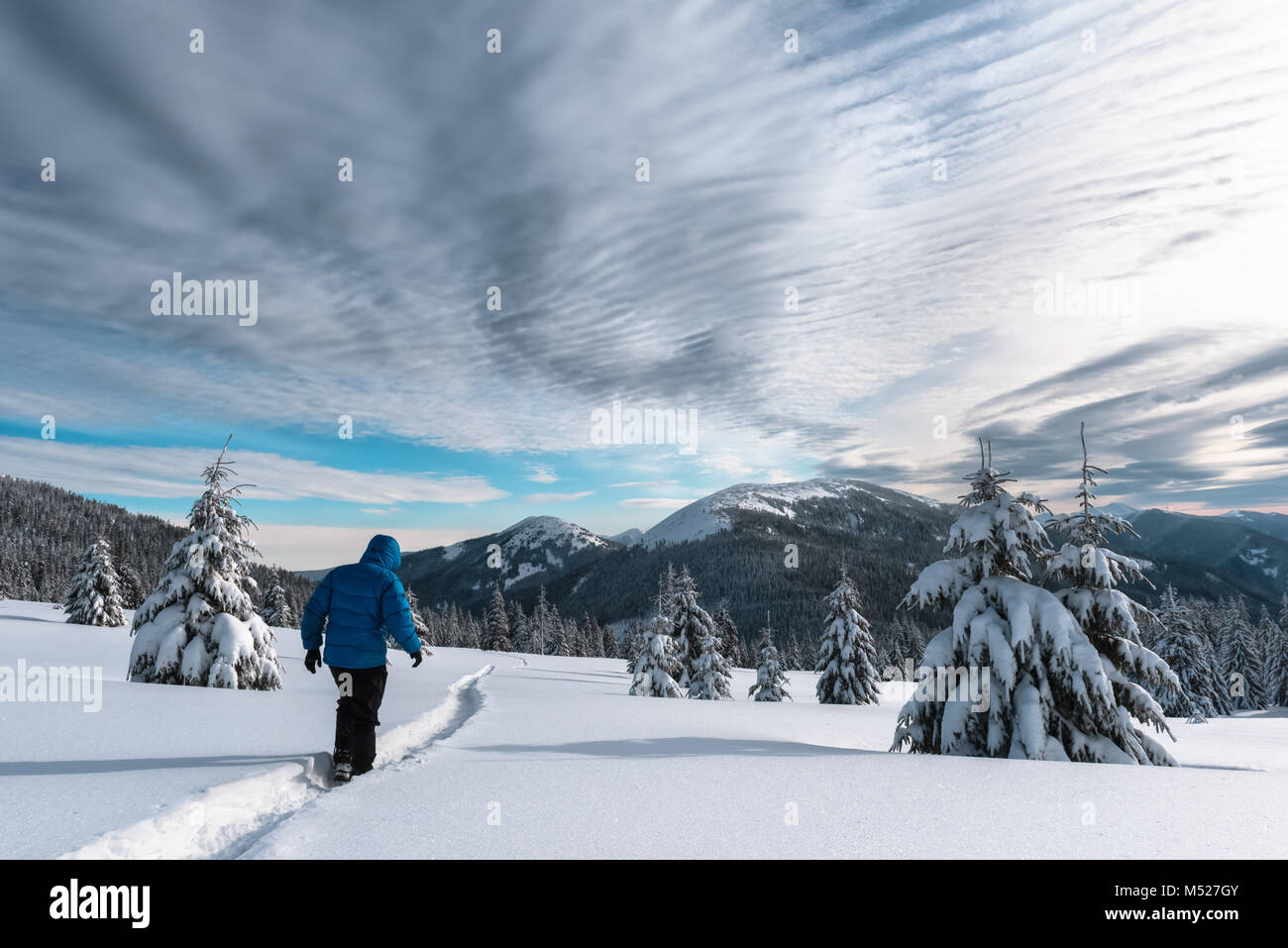 Alone tourist in the high mountains in winter time Stock Photo