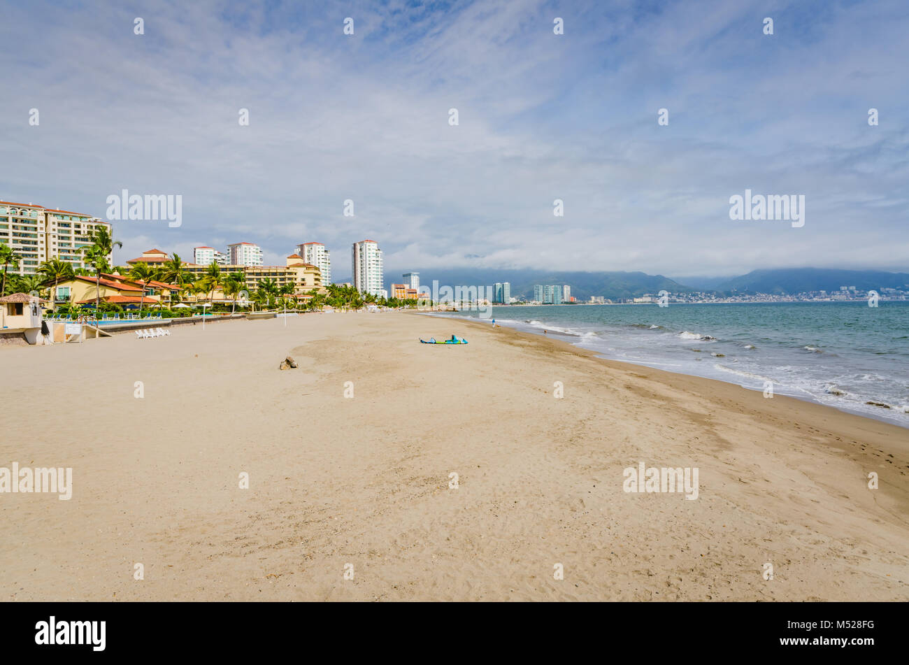 Scenic view of empty stretch of beach bordered by luxury resorts. Stock Photo