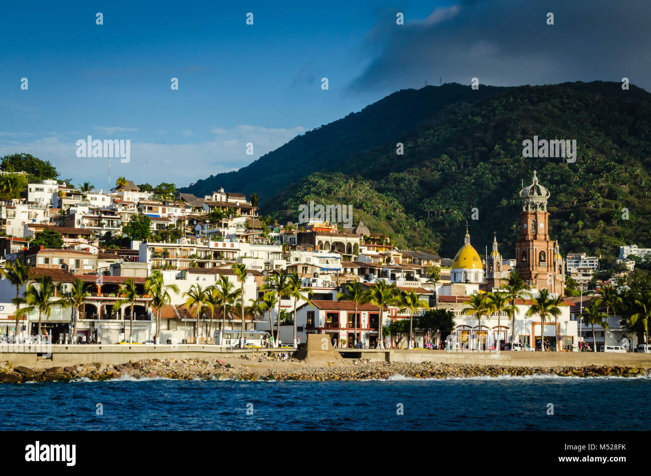 Shoreline view of Puerto Vallarta, Jalisca, Mexico includes Malecon, shops, and cathedral. Stock Photo
