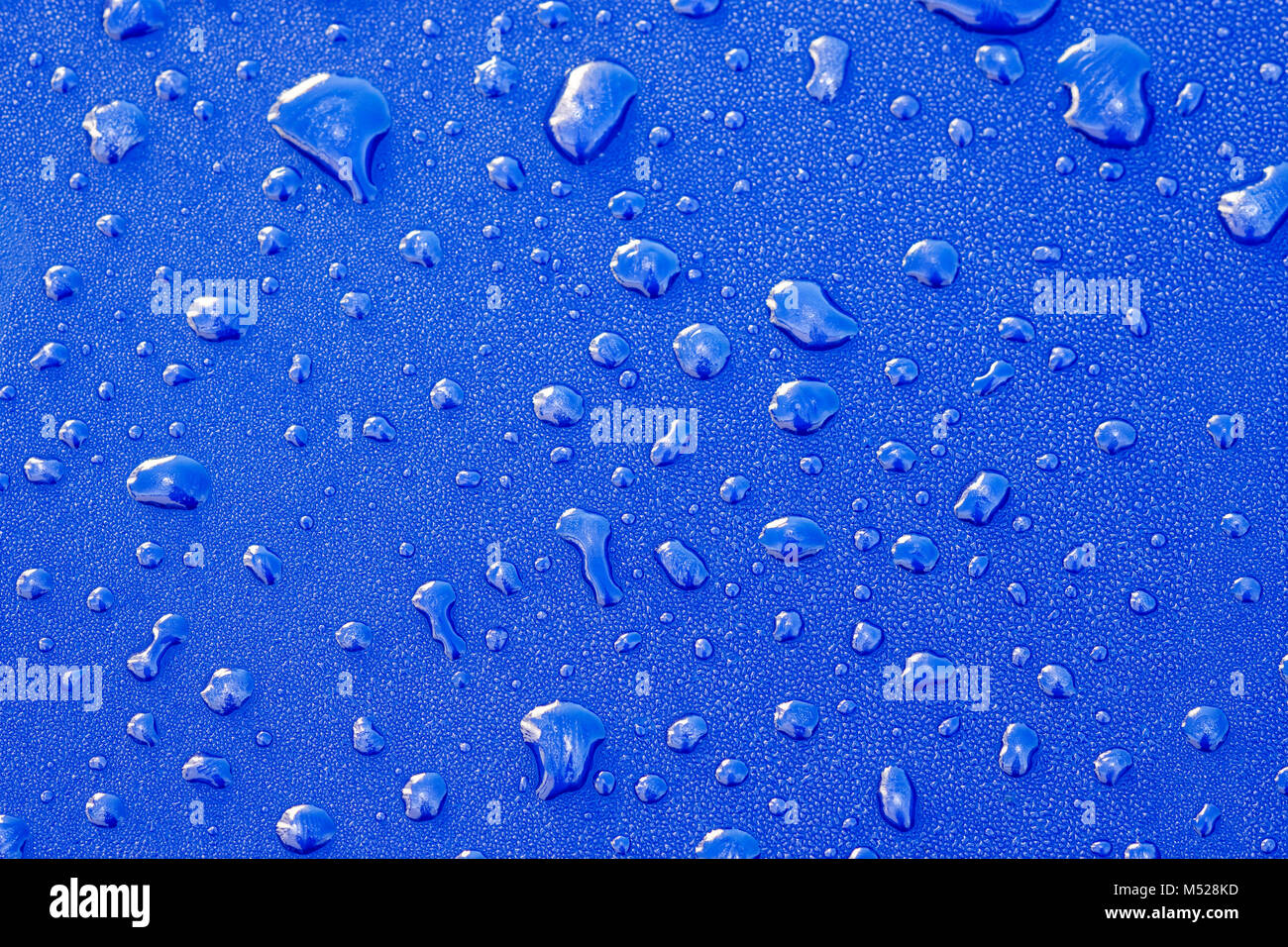 Details,Water droplets on blue paint Stock Photo