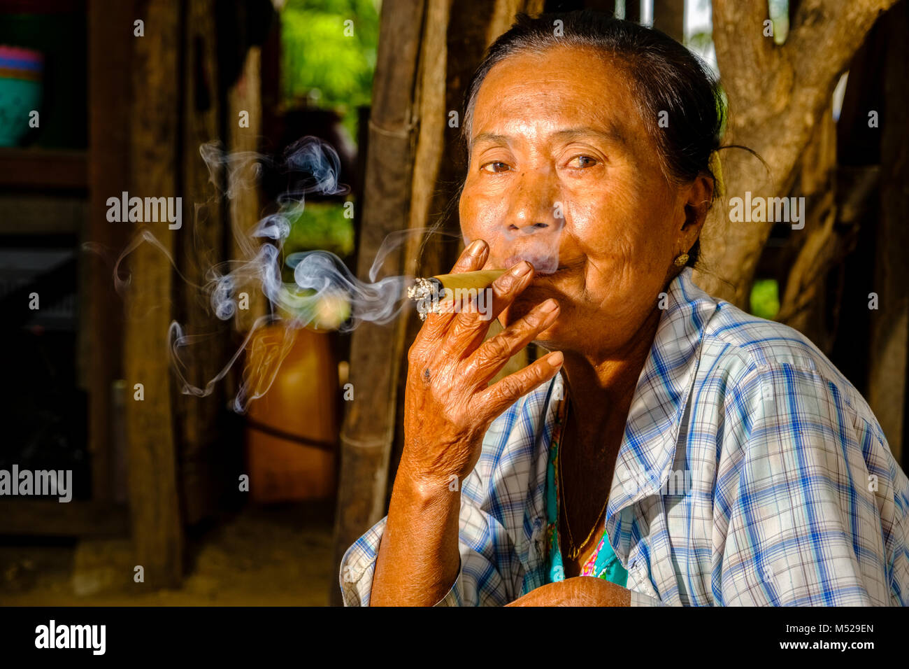 Portrait of a woman smoking a Cheerot, a local cigar Stock Photo