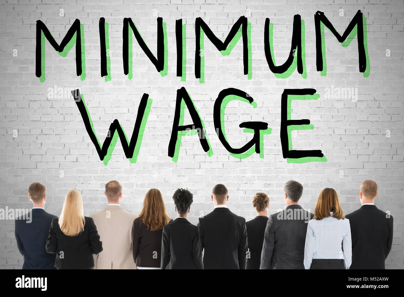 Group Of People Looking At Minimum Wage And Social Security Stock Photo