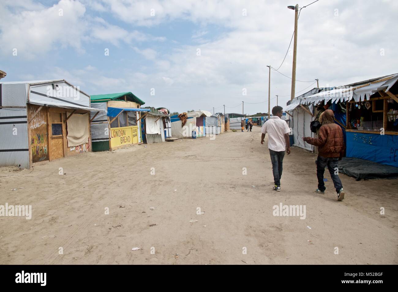 Migrants Walk Through The Camp In Calais, Where Thousands Were Living ...