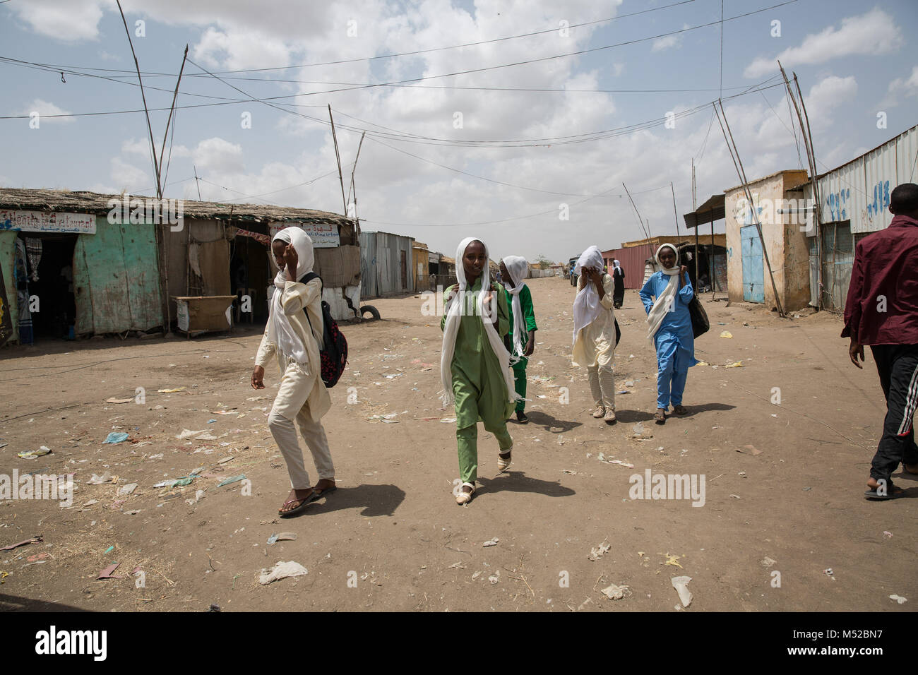 Young refugees walk to school in Shagarab refugee camp, eastern Sudan. Tens of thousands of refugees live here, after escaping mandatory, unending military service and repression in their home country. Stock Photo