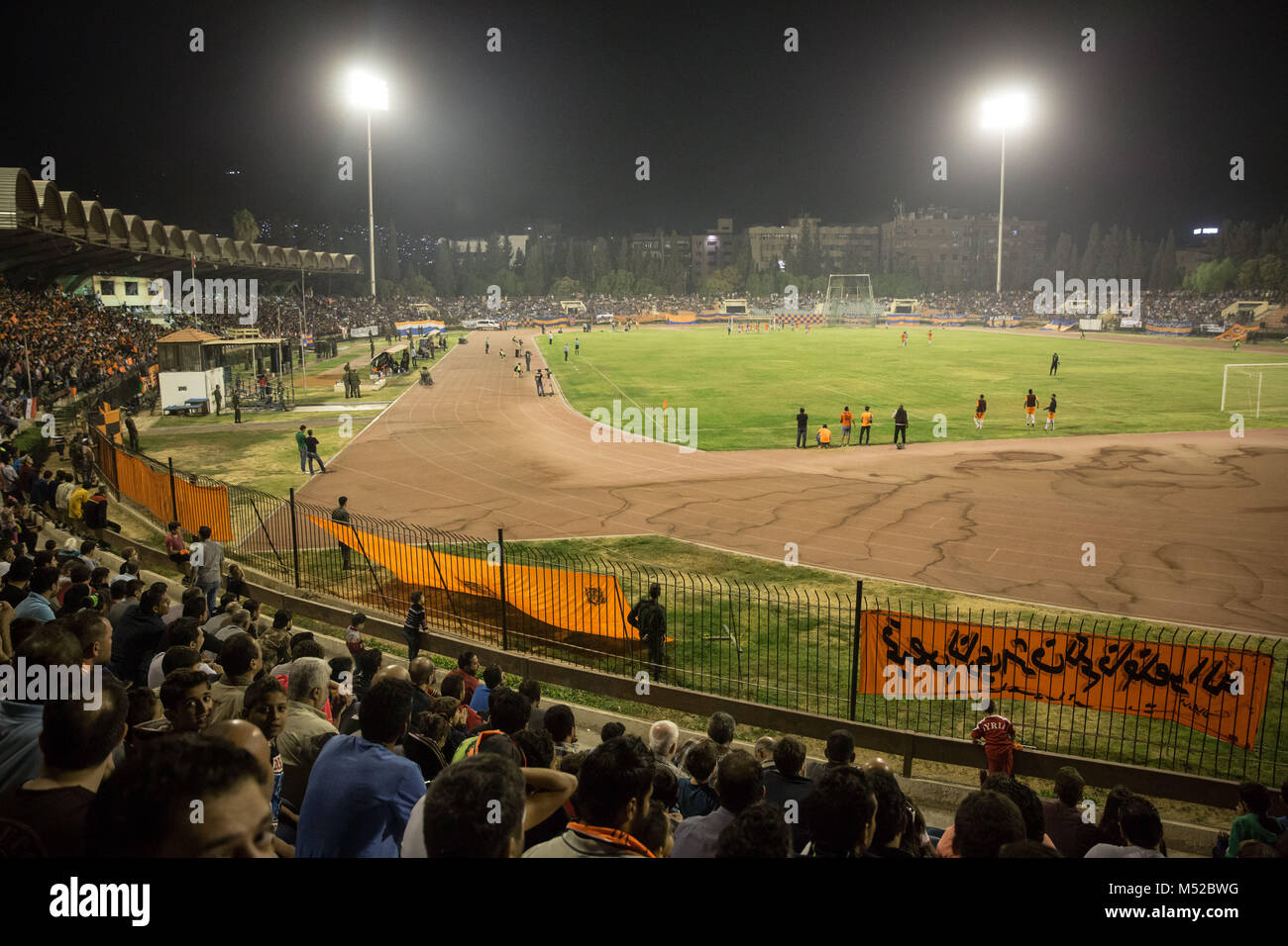 Al-Wahda from Damascus and Al-Karamah from Homs play in Tishreen Stadium in the Syrian Cup Final, October 2017. The Syrian football cup final was played between Al-Wahda and Al-Karamah football teams. Despite ongoing conflict in the war torn country of Syria, the Syrian football cup final was hosted in the capital city of Damascus which is under the Syrian government control with many locals football fans attended the match. Stock Photo