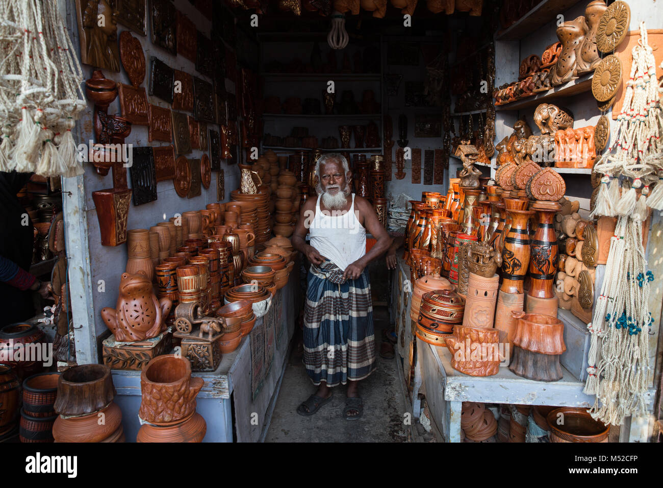 An Old Man Stands Proud In The Door Of His Clay Pot Shop