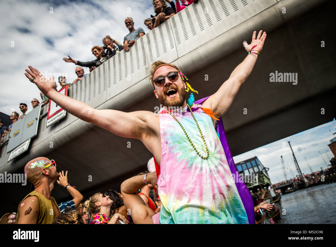 A participant seen celebrating in his colorful top. Amsterdam Pride Parade 2017 hosted in the canals of the Dutch capital city. Stock Photo